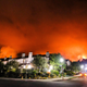 Smoke rising from a brush fire behind homes in the Pacific Palisades area of Los Angeles Saturday, May 15.